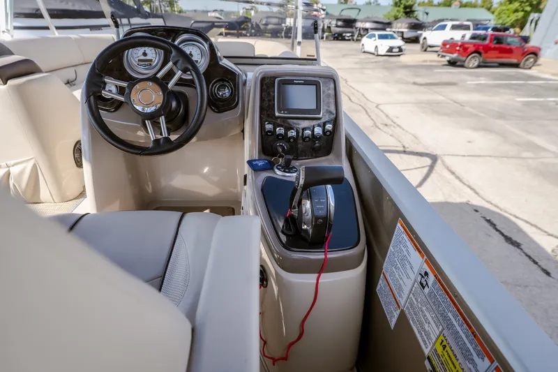 Slide: The Image of 2017 Princecraft Vogue 25 XT boat dashboard with steering wheel and control panel. - 31