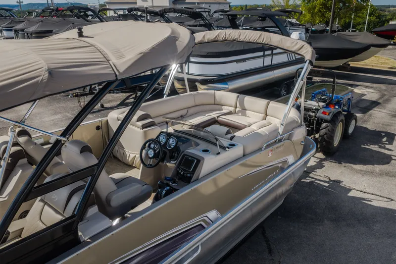 Slide: The Image of 2017 Princecraft Vogue 25 XT pontoon boat with beige seating and canopy in a marina. - 11