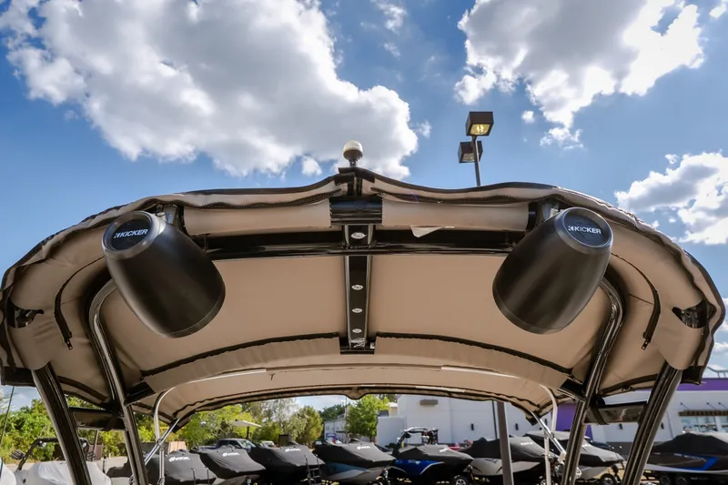 Slide: The Image of 2017 Princecraft Vogue 25 XT boat canopy with speakers under a blue sky. - 23