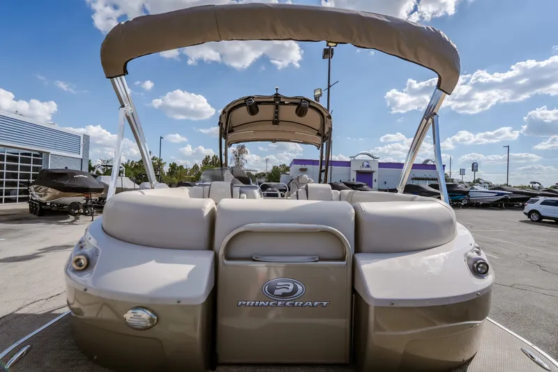 Slide: The Image of 2017 Princecraft Vogue 25 XT pontoon boat with canopy, parked outdoors under a blue sky. - 14