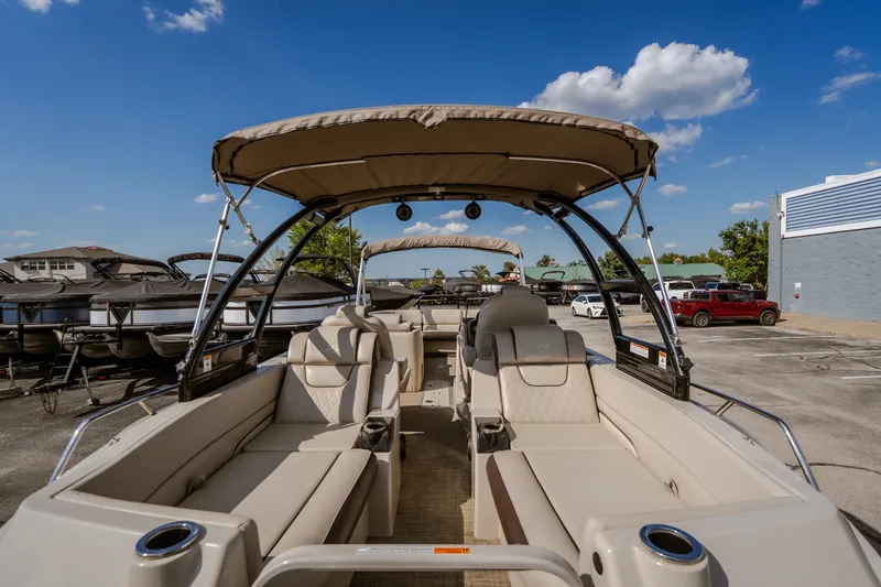 Slide: The Image of 2017 Princecraft Vogue 25 XT pontoon boat with beige seating and canopy, parked outdoors. - 36