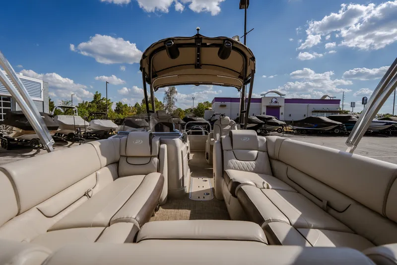 Slide: The Image of 2017 Princecraft Vogue 25 XT pontoon boat with spacious seating and canopy under a clear sky. - 19