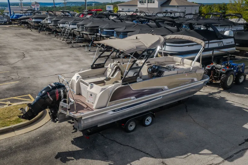 Slide: The Image of 2017 Princecraft Vogue 25 XT pontoon boat on trailer in marina lot. - 10