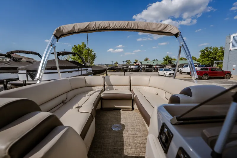 Slide: The Image of 2017 Princecraft Vogue 25 XT pontoon boat with spacious seating and canopy under a clear sky. - 27