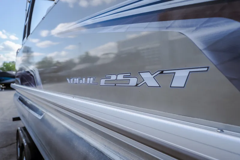 Slide: The Image of 2017 Princecraft Vogue 25 XT boat side view with logo and sleek design. - 15