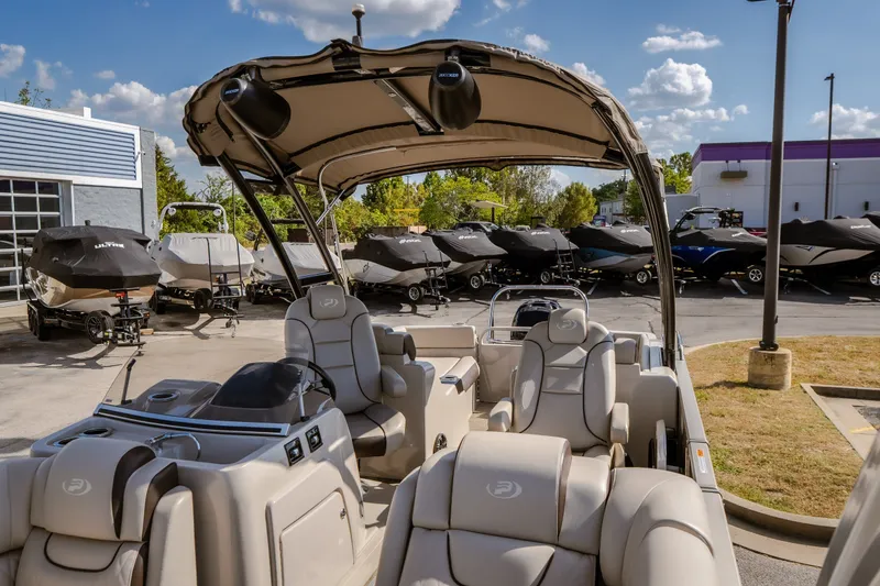 Slide: The Image of 2017 Princecraft Vogue 25 XT pontoon boat with luxurious seating, parked at a dealership. - 22
