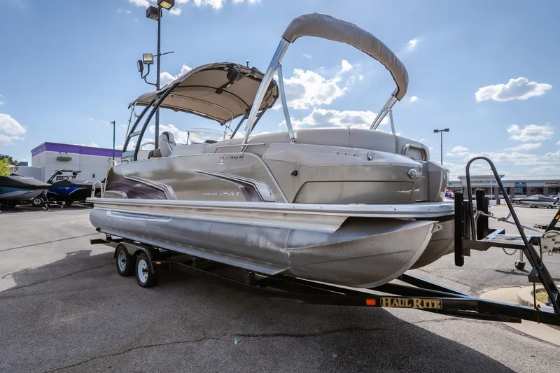 Slide: The Image of 2017 Princecraft Vogue 25 XT pontoon boat on trailer under sunny sky. - 9