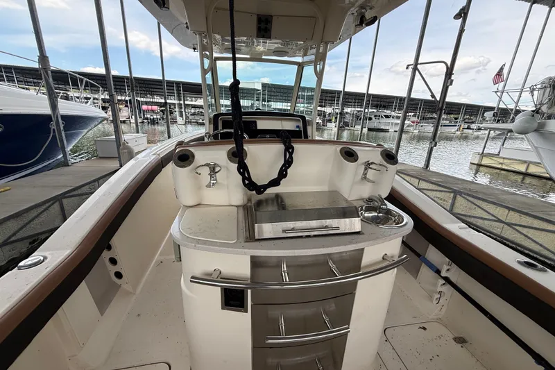 Slide: The Image of Interior view of a 2014 Scout 275 LXF boat docked at a marina. - 9