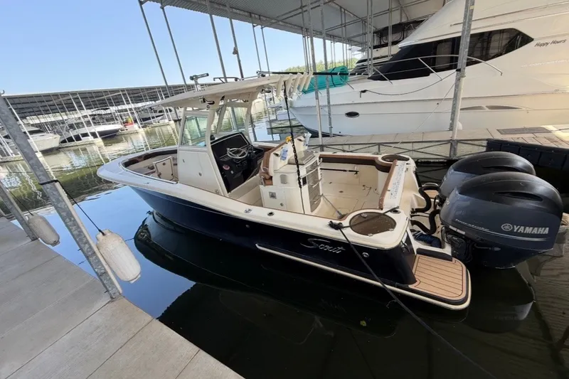 Slide: The Image of 2014 Scout 275 LXF boat docked with twin Yamaha engines. - 5