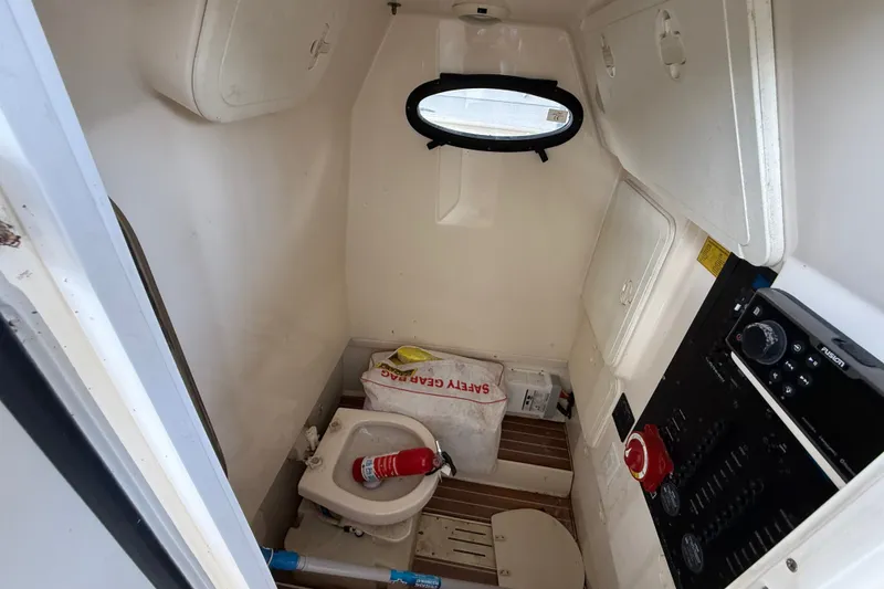 Slide: The Image of Interior cabin of 2014 Scout 275 LXF boat with toilet and safety gear. - 10