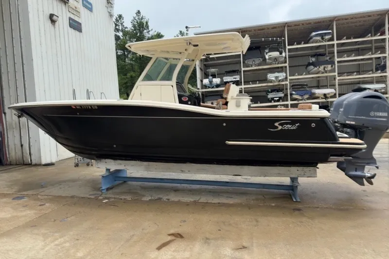Slide: The Image of 2014 Scout 275 LXF boat with Yamaha engine on display in a storage facility. - 1