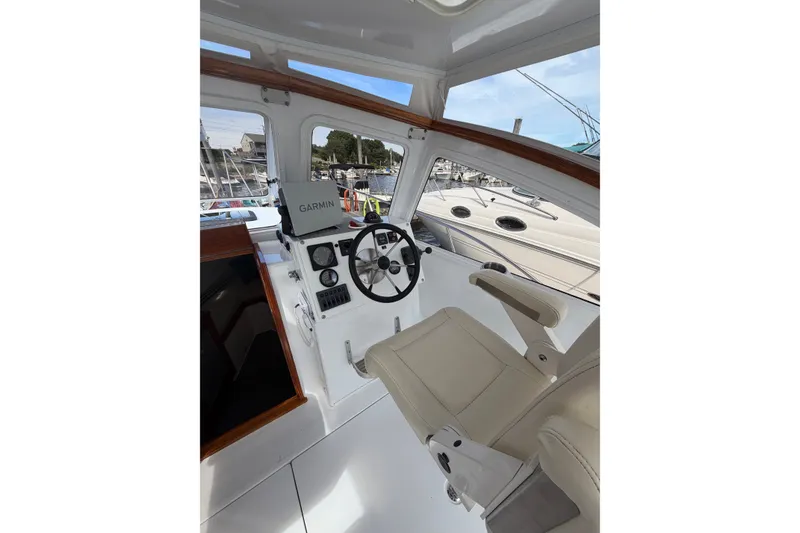 Slide: The Image of Interior of 2000 Webber's Cove Pemaquid Beach boat with steering wheel and Garmin navigation. - 18