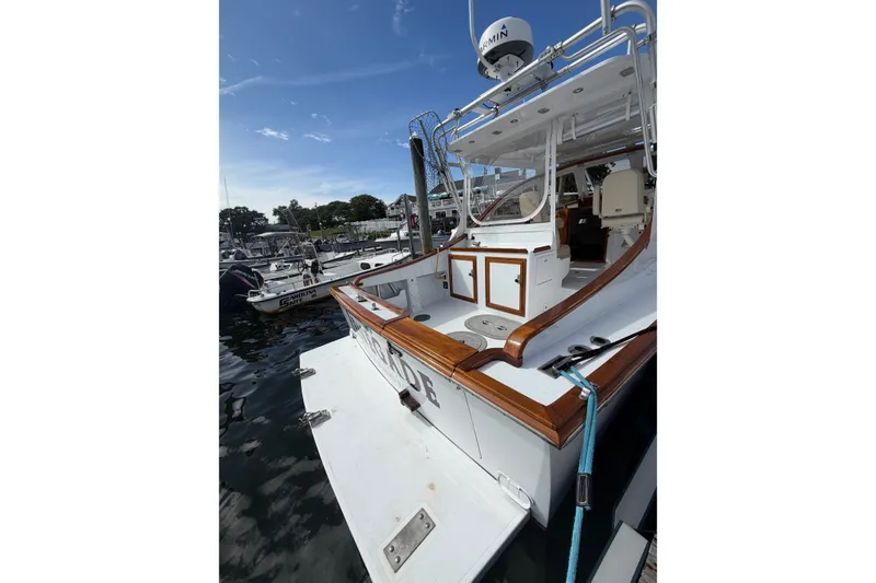 Slide: The Image of 2000 Webber's Cove Pemaquid Beach boat docked, featuring wooden accents and a spacious deck. - 14