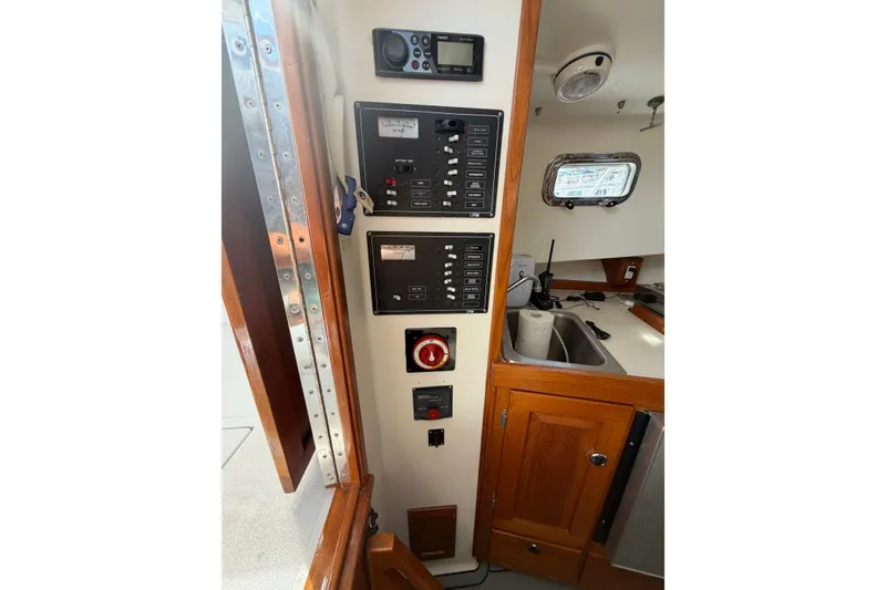 Slide: The Image of Control panel and kitchenette inside a 2000 Webber's Cove Pemaquid Beach boat. - 22