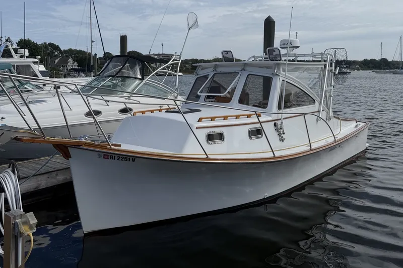 The Image of 2000 Webber's Cove Pemaquid Beach boat docked at marina, featuring sleek design and white hull. - 0