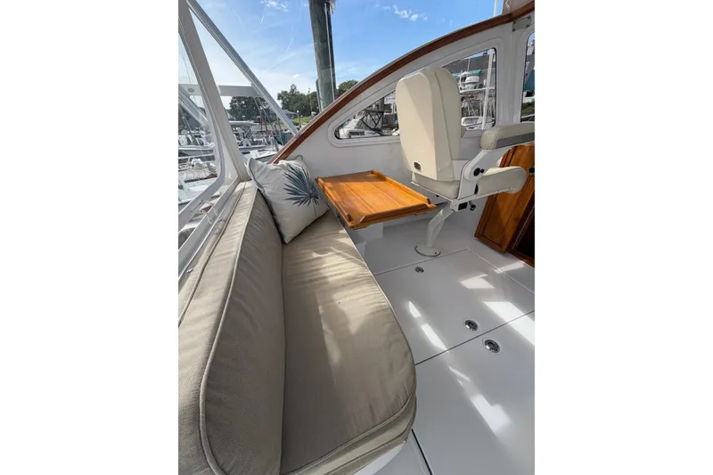 Slide: The Image of Interior of 2000 Webber's Cove Pemaquid Beach boat with cushioned seating and wooden table. - 17