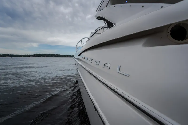 Slide: The Image of 2009 Regal Commodore 4460 yacht on calm waters under cloudy sky. - 35