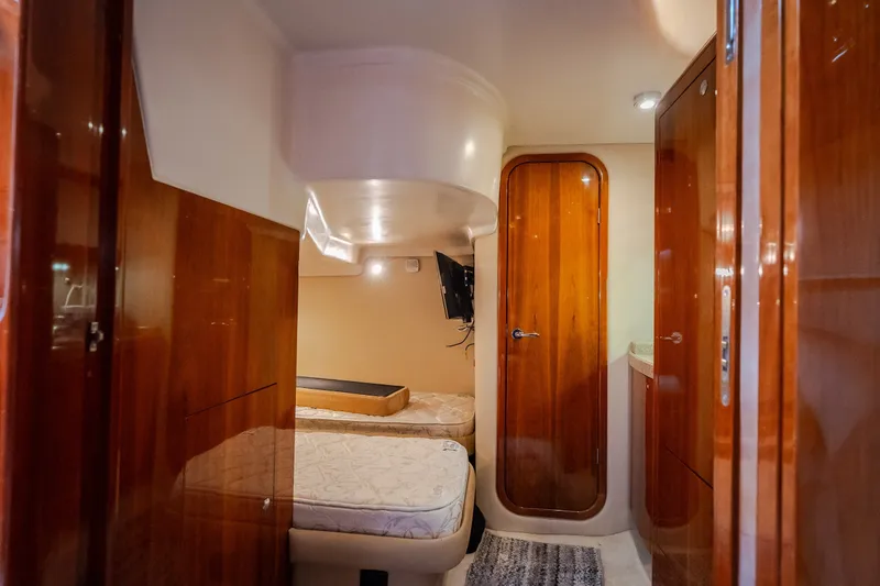 Slide: The Image of Interior cabin of 2009 Regal Commodore 4460 yacht with wooden finishes and twin beds. - 50