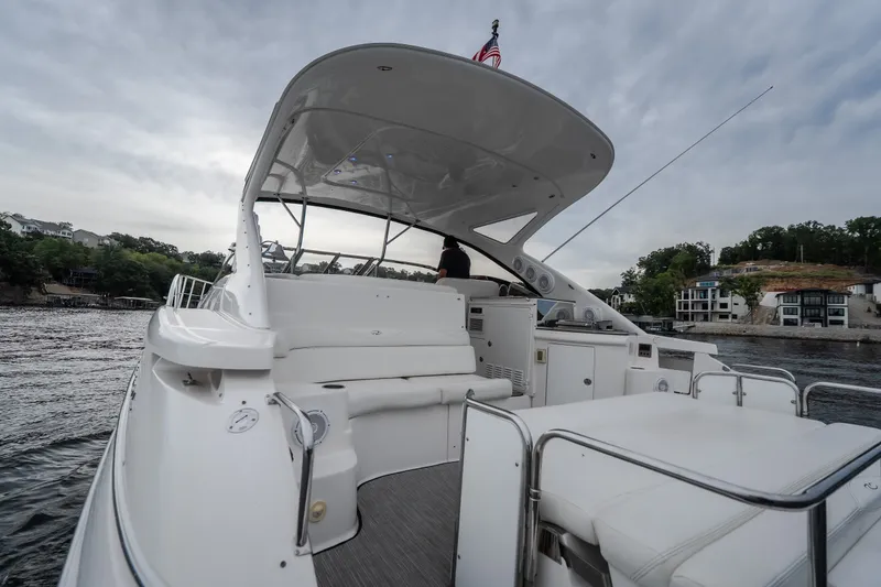 Slide: The Image of 2009 Regal Commodore 4460 yacht on water, featuring spacious deck and modern design. - 9