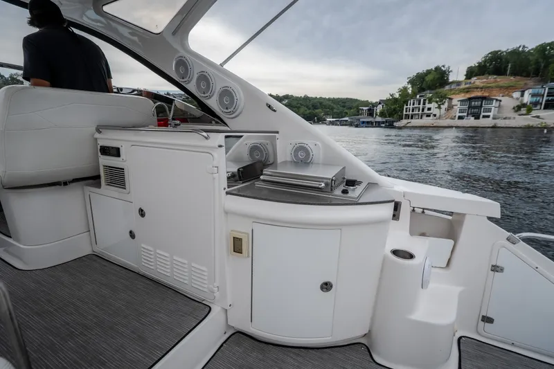 Slide: The Image of 2009 Regal Commodore 4460 yacht interior with sleek design and modern amenities on a scenic waterway. - 12
