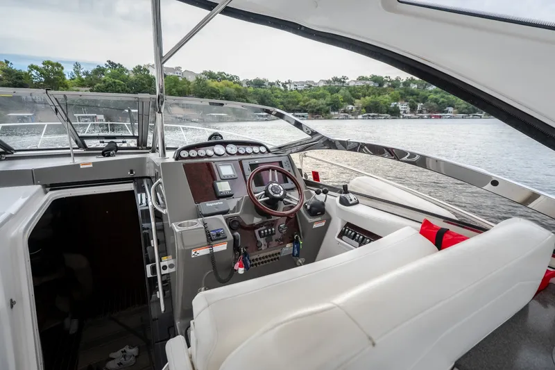 Slide: The Image of Interior view of 2009 Regal Commodore 4460 yacht cockpit with steering wheel and controls. - 21