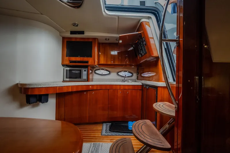 Slide: The Image of Luxurious 2009 Regal Commodore 4460 yacht interior with modern kitchen and wooden finishes. - 39