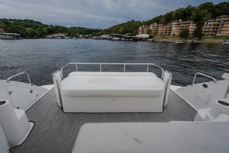 Slide: The Image of Rear deck view of 2009 Regal Commodore 4460 yacht on a scenic lake. - 36