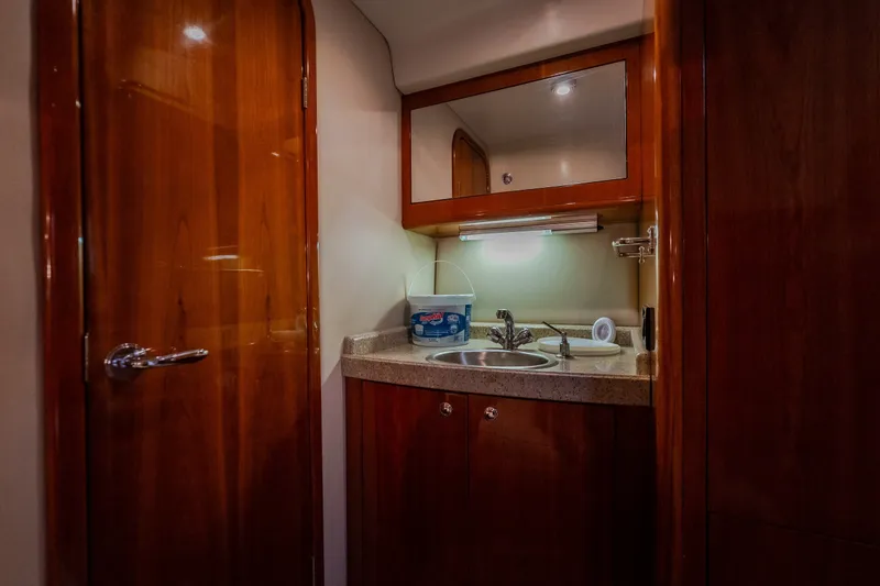 Slide: The Image of Luxurious 2009 Regal Commodore 4460 yacht bathroom with wooden cabinetry and modern sink. - 53