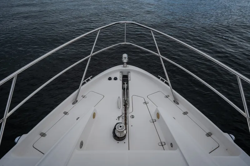 Slide: The Image of Bow view of 2009 Regal Commodore 4460 yacht on calm water. - 31