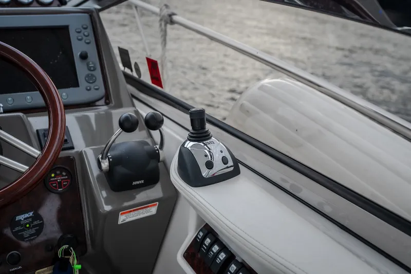Slide: The Image of 2009 Regal Commodore 4460 yacht helm with joystick control and navigation display. - 24