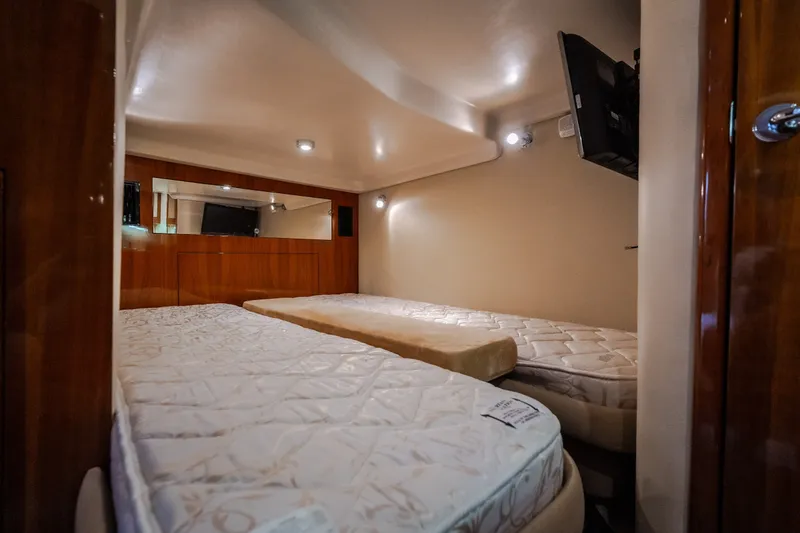Slide: The Image of Interior cabin of 2009 Regal Commodore 4460 yacht with twin beds and TV. - 51