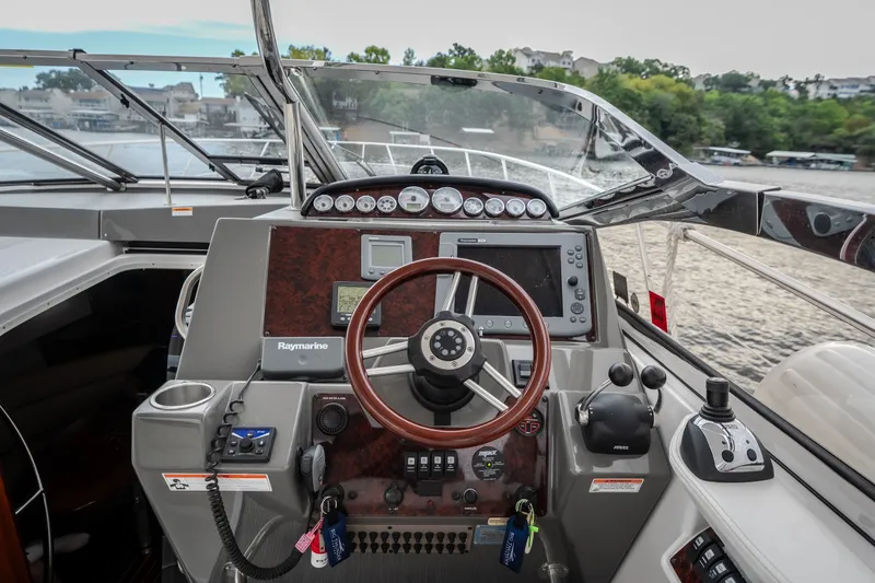 Slide: The Image of Helm of 2009 Regal Commodore 4460 yacht with steering wheel and navigation controls. - 22