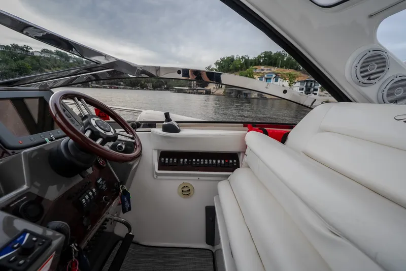 Slide: The Image of Interior view of 2009 Regal Commodore 4460 boat with steering wheel and seating. - 25