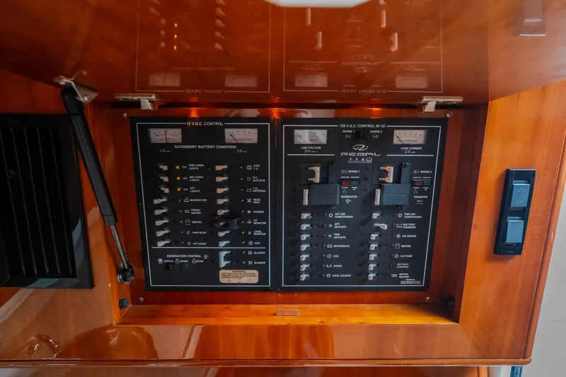 Slide: The Image of Control panel of a 2009 Regal Commodore 4460 boat, featuring various switches and gauges. - 43