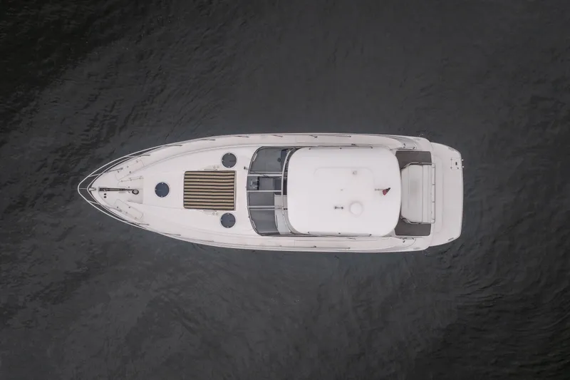 Slide: The Image of Aerial view of 2009 Regal Commodore 4460 yacht on dark water. - 5