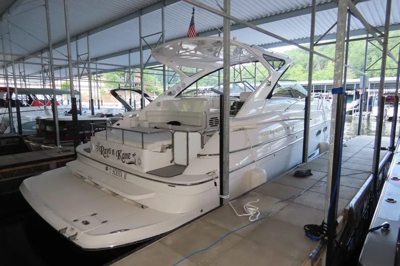 The Image of 2009 Regal Commodore 4460 yacht docked in a covered marina. - 1