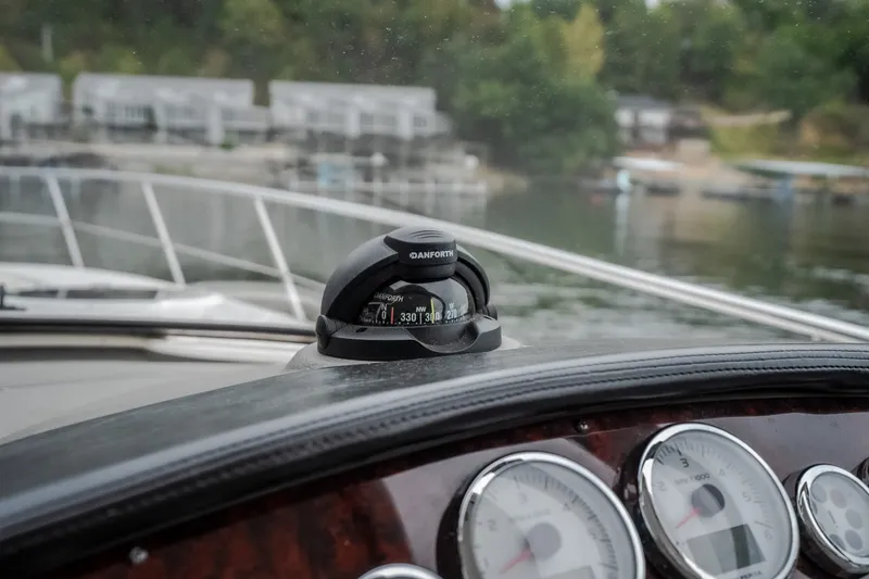 Slide: The Image of Dashboard view of 2009 Regal Commodore 4460 boat with compass and gauges. - 54