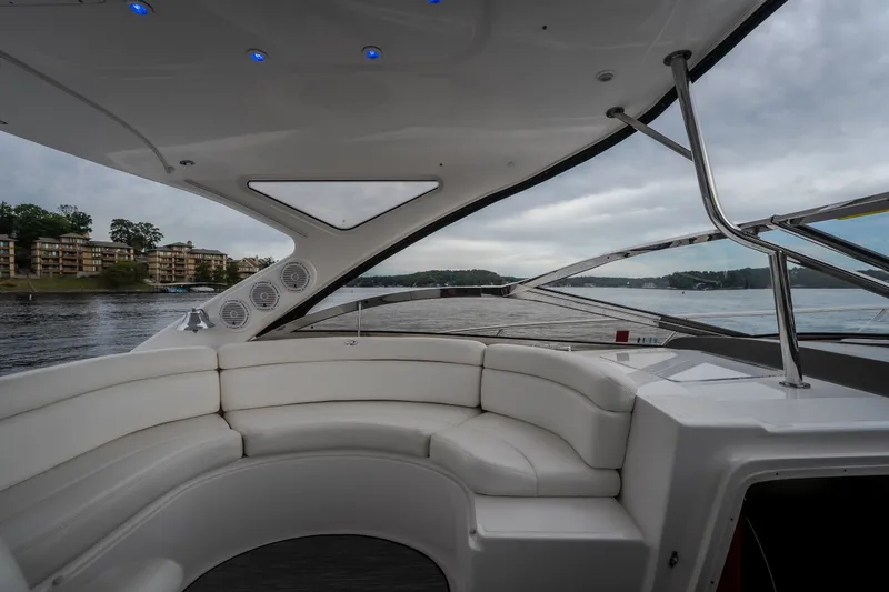 Slide: The Image of Luxurious 2009 Regal Commodore 4460 yacht interior with white seating and scenic water view. - 26