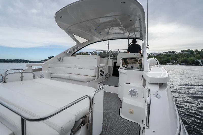 Slide: The Image of 2009 Regal Commodore 4460 yacht interior with spacious seating and modern design on a serene lake. - 8