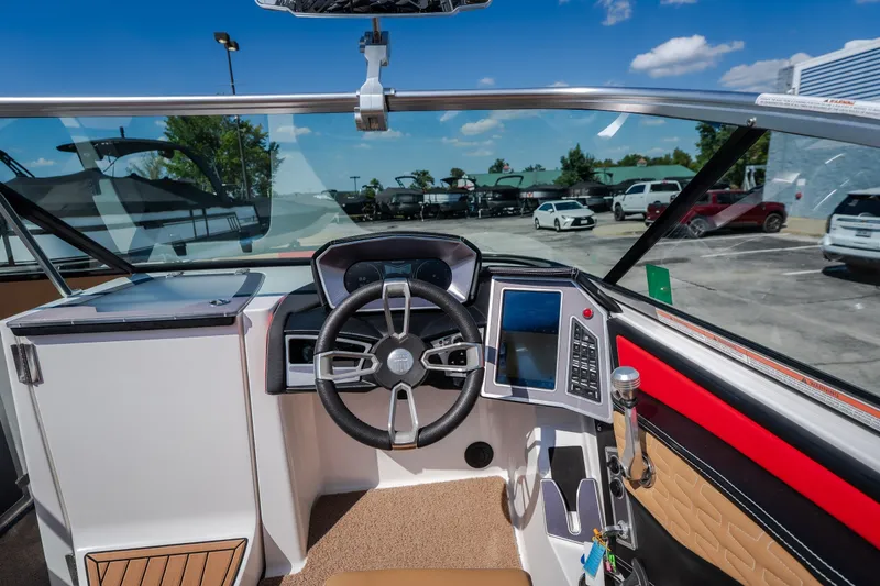 Slide: The Image of Interior view of 2020 MasterCraft X26 boat cockpit with modern steering and controls. - 38