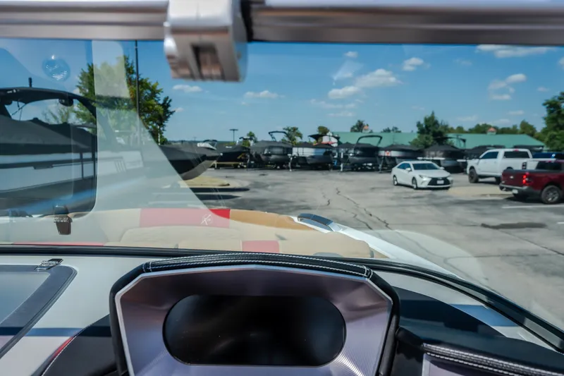 Slide: The Image of 2020 MasterCraft X26 boat dashboard view with parking lot and vehicles in the background. - 39