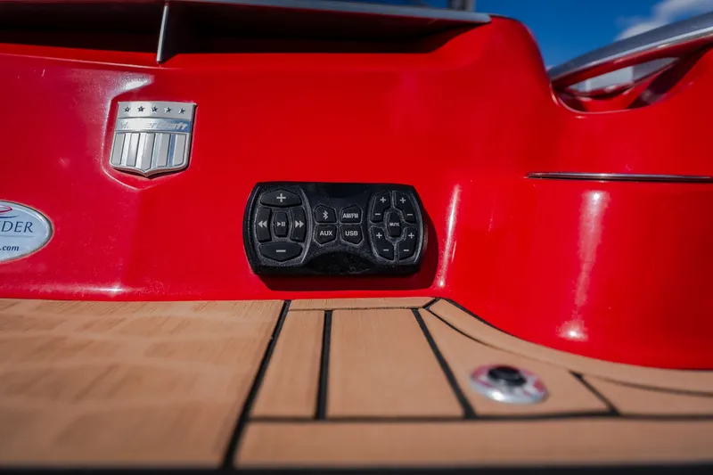 Slide: The Image of 2020 MasterCraft X26 boat dashboard with control panel and red exterior. - 13