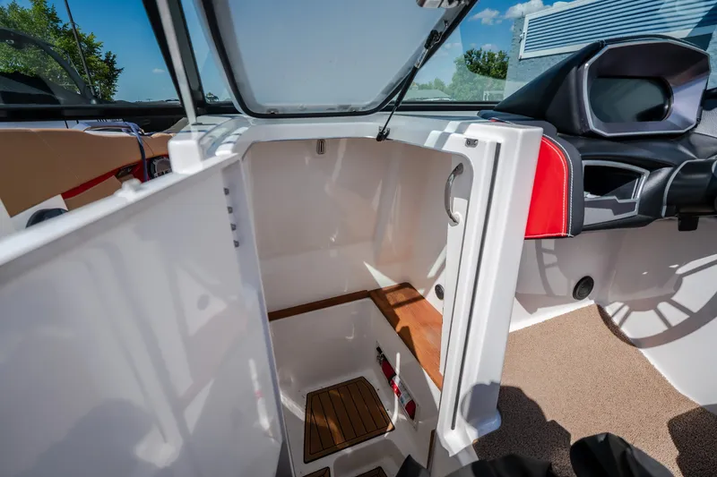 Slide: The Image of 2020 MasterCraft X26 boat interior with open storage compartment and sleek design. - 32