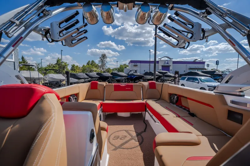 Slide: The Image of 2020 MasterCraft X26 boat interior with luxurious seating and modern design under a sunny sky. - 41