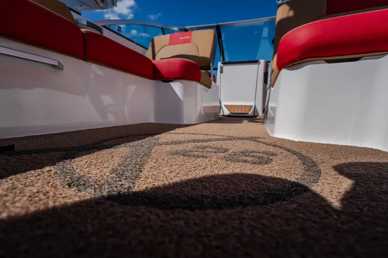 Slide: The Image of Interior view of 2020 MasterCraft X26 boat with red seating and logo carpet. - 49