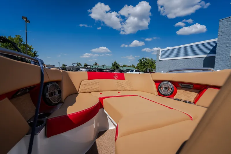 Slide: The Image of Luxurious interior of 2020 MasterCraft X26 boat with tan and red seating under blue sky. - 28