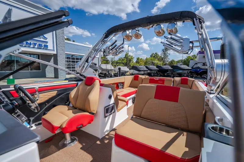 Slide: The Image of 2020 MasterCraft X26 boat interior with luxurious seating and modern design under a sunny sky. - 24
