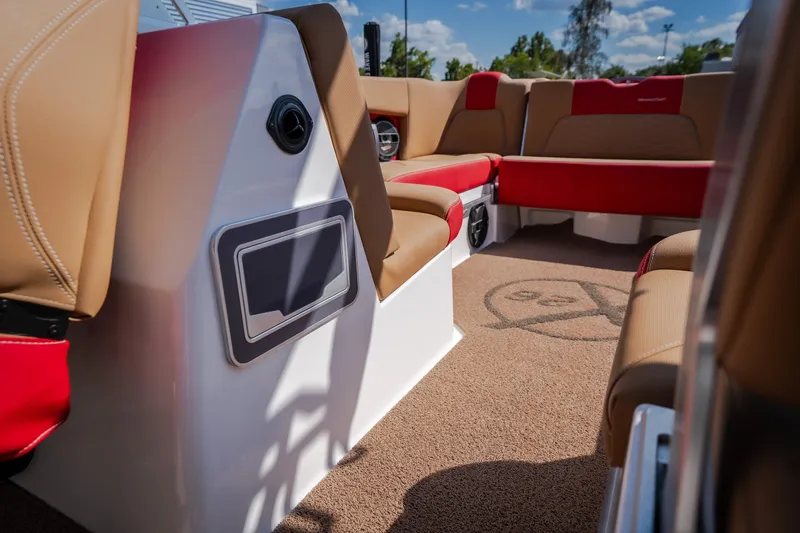 Slide: The Image of Interior of a 2020 MasterCraft X26 boat with tan and red seating. - 43