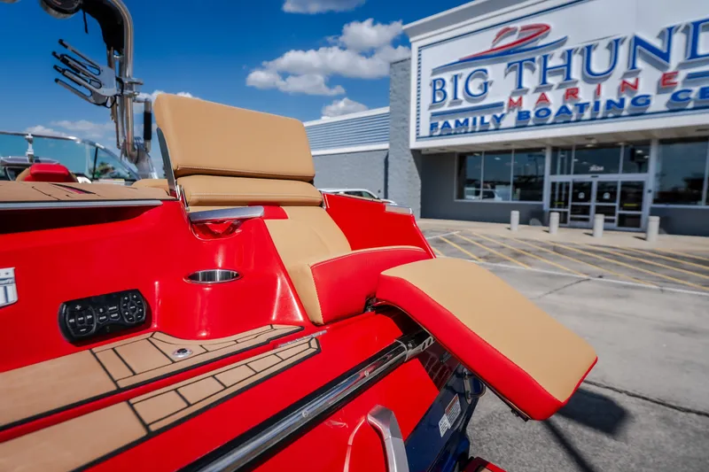 Slide: The Image of 2020 MasterCraft X26 boat at Big Thunder Marine dealership, showcasing red and tan seating. - 16