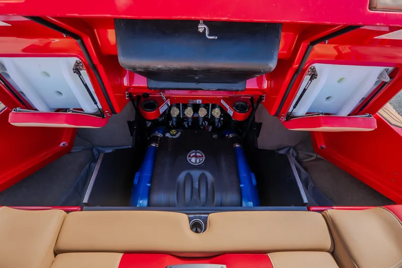 Slide: The Image of 2020 MasterCraft X26 engine compartment with red and tan interior detailing. - 54
